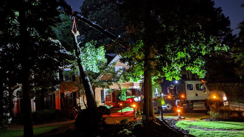Crane lifting fallen tree off of home in Dunwoody, GA